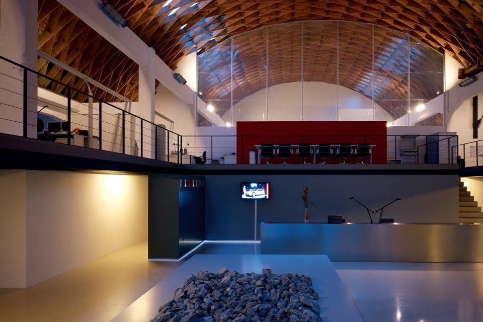 Modern loft interior with industrial ceiling, open plan living space, and integrated lighting