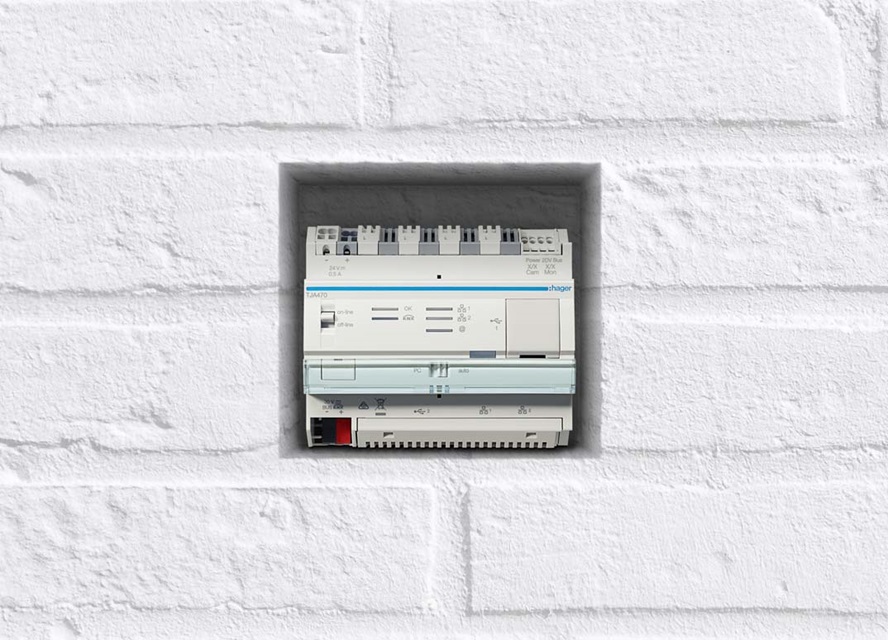 Hager electrical distribution board installed in a white brick wall