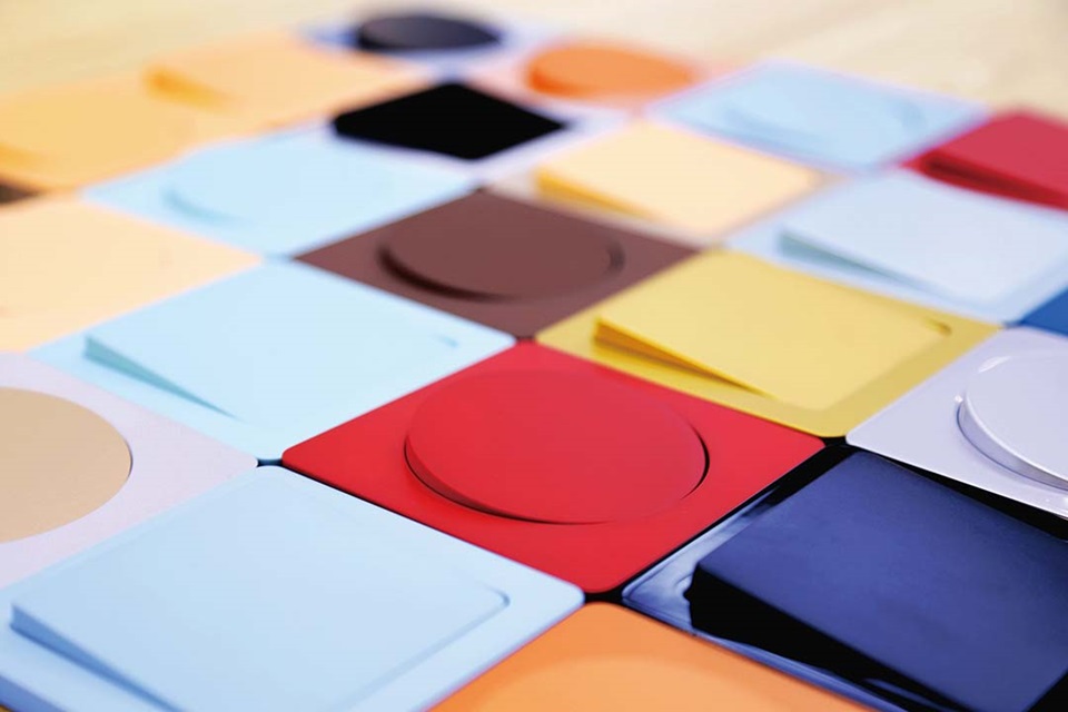 Assorted colorful electrical wall plates displayed