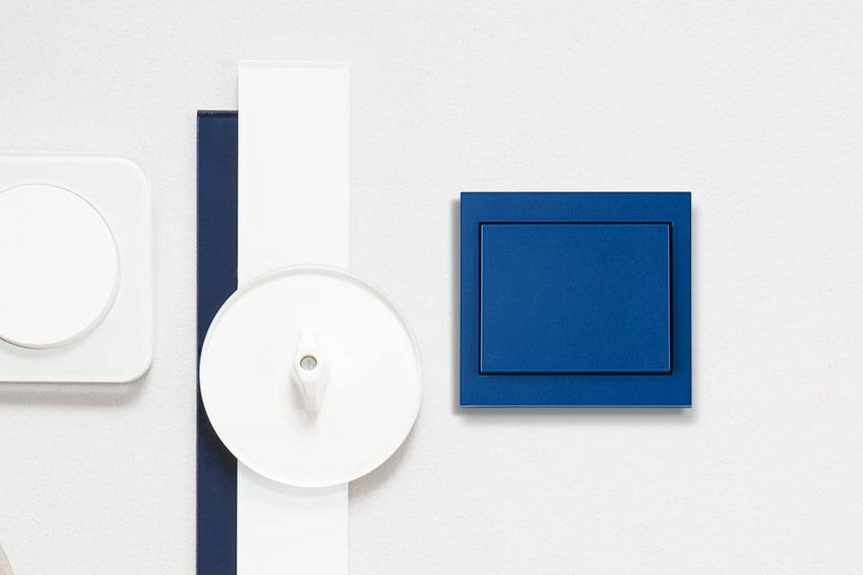 White and blue electrical wall switches mounted on wall