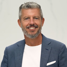 Professional adult wearing a blazer and smiling